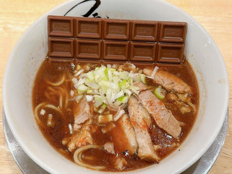 A bowl of ramen with a chocolate bar on top for Valentine's Day