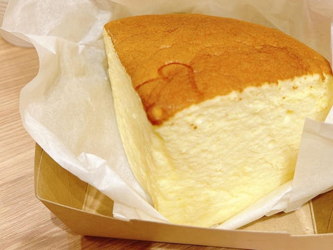 A slice of a fluffy cheesecake showing the cake-like texture