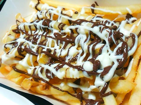 A basket of fries with a double chocolate sauce on top for a Valentine's treat