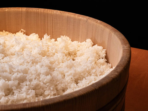 A Japanese bamboo bowl of fluffy Japanese sushi rice