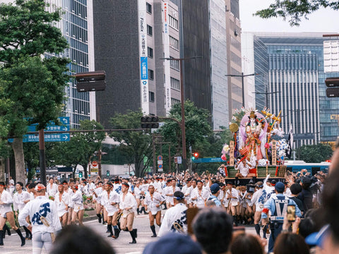 Men in festival garb carry a Mikoshi float at the Hakata Dontaku Festival, a Golden Week festival