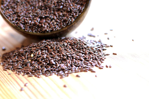 Flax seeds spilling from bowl