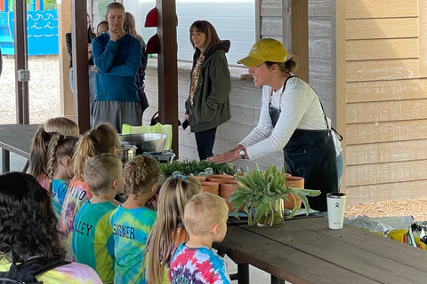 Tavern Owner Maggie Noble plants an edible garden with New Wilmington’s little growers at Marti Park.