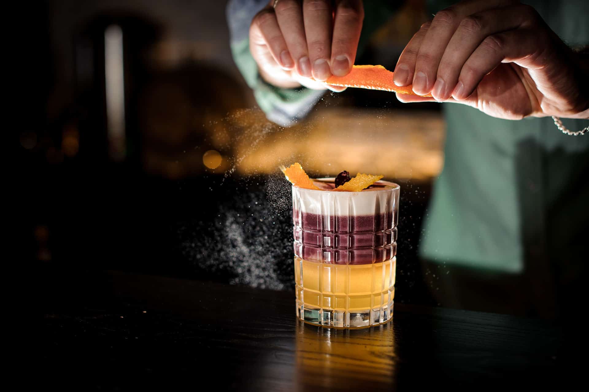 Bartender crafting a New York Sour cocktail