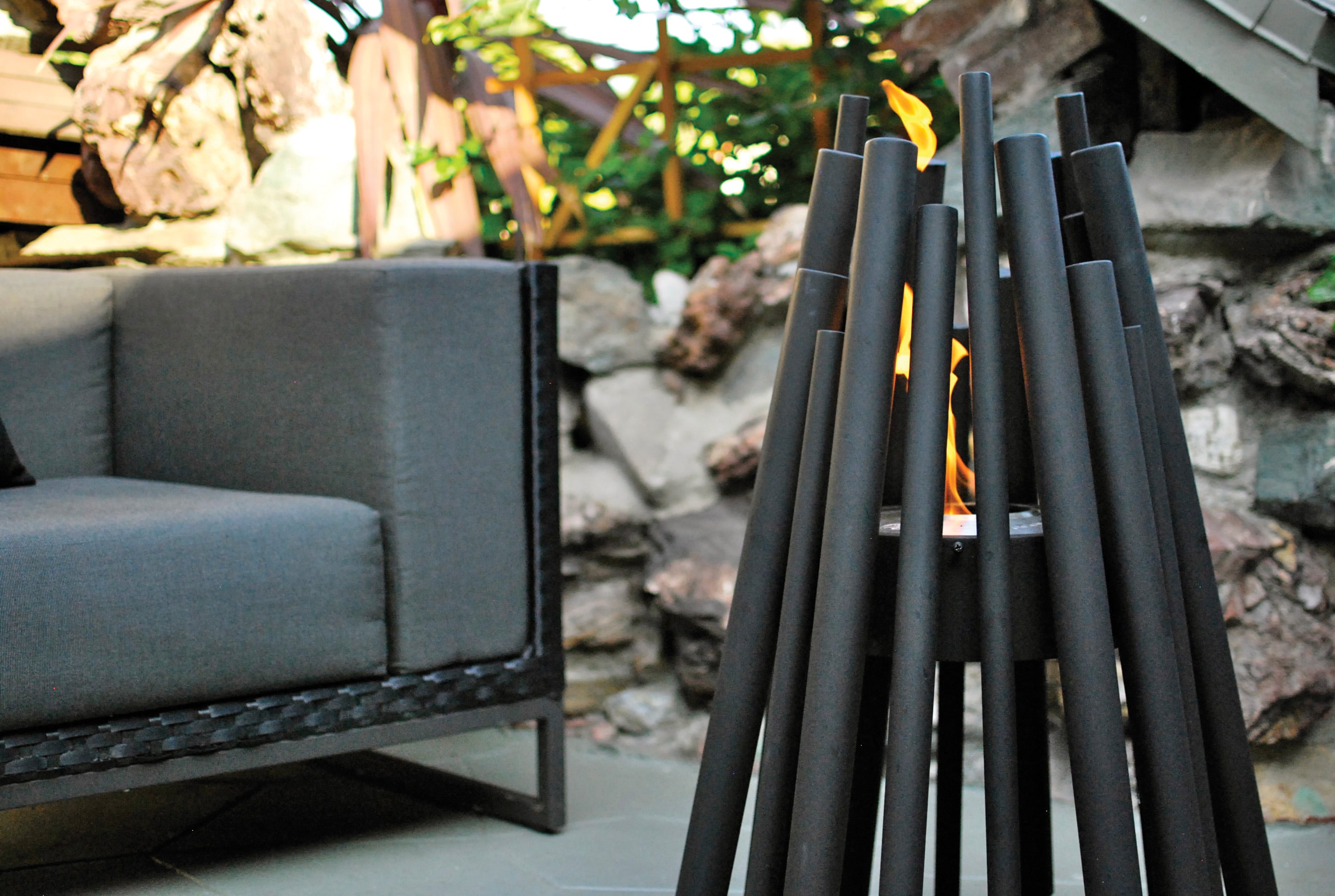 Stix in black next to outdoor sofa close up