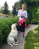 Woman with her dog in a backyard.