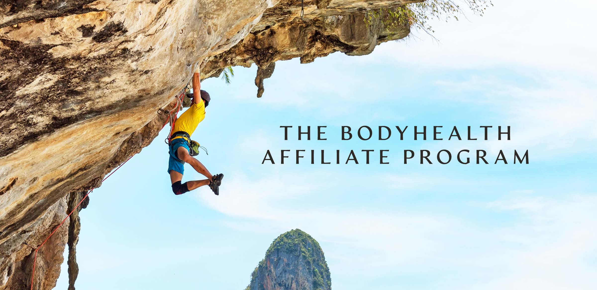 Athletic Male rock climbing and hanging from the side of a mountain.