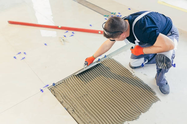 man working with ceramic tiles