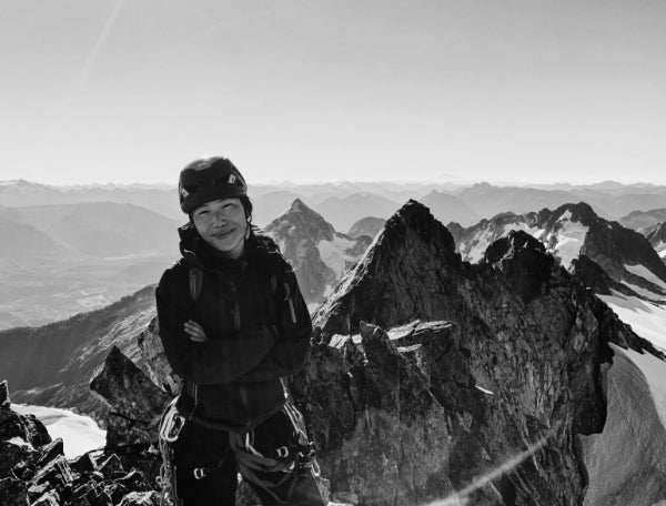 Black and white image of rock climber Vannavee Pornsinsiriruk, Vanny P alpine climbing in the Canadian Rockies