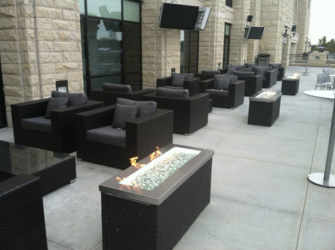 The Grey Key Largo Gas Fire Pit Table is a stunning display of fire, captivating with its radiant flames gracefully dancing upon a bed of shimmering fire glass.