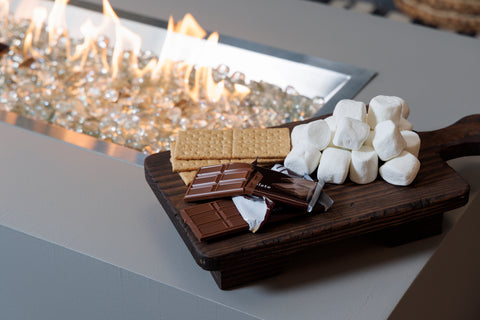 All the makings for s'mores are set on top of the Harbor View Fire Pit Table.