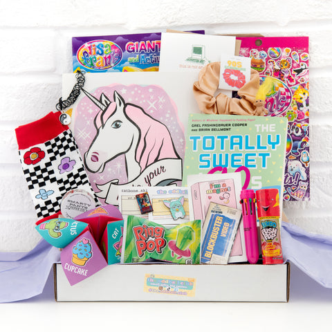 Get nostalgic with our 90s themed subscription box, featuring a unicorn art print, blockbuster magnet, ring pop, Lisa Frank stickers, and comfy socks. Join The Oddball Club and receive unique and quirky items every month! Order now and add a touch of fun to your life.