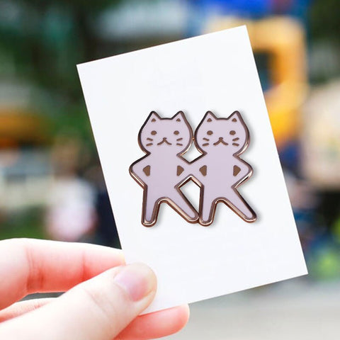 enamel pin of two twin cats dancing like the girl emojis