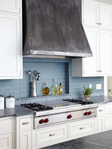 zinc range hoods in wall version hanging in a kitchen