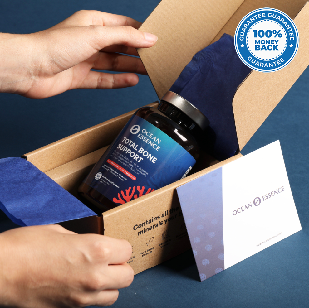 A bottle of Ocean Essence Total Bone Support supplements with a 100% money-back guarantee label.