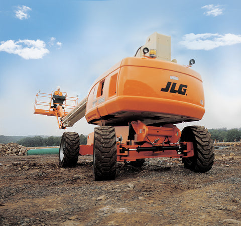 A JLG Boom lift parked on a construction site with the blue sky in the background.