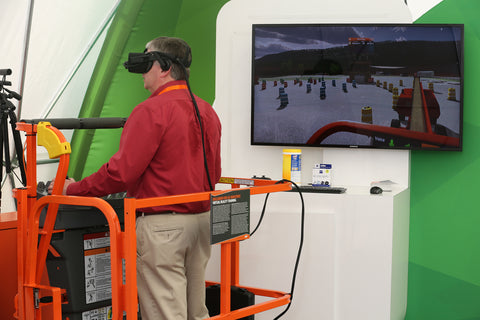 A picture of a man sitting in a platform with an AR headset operating a boomlift in a simulation.