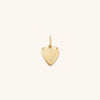 Puffy Heart Charm: A close-up of a gold heart-shaped pendant, perfect for adding charm to bracelets or necklaces to celebrate love.