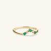 Emerald and Diamond Wishbone Ring: A 14k gold ring featuring emerald gemstones and responsibly sourced diamonds, designed for standout stacking.