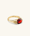 Heirloom Ring featuring a gold band with a prominent red gemstone, designed for timeless elegance and lasting admiration.