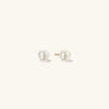 Pearl Oversized Studs: Close-up view of handcrafted 18k gold vermeil earrings featuring freshwater pearls.