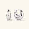 Sculptural Hoops: a pair of silver earrings with a bold, curved design, handcrafted in 18k gold vermeil.