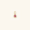 Close-up of the Birthstone Sphere Charm, a blue sapphire pendant set in 14k solid gold, symbolizing love and fidelity.