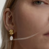 Close-up of a woman’s ear adorned with the Puffy Charlotte Pearl Drop Earring, featuring puffy tiers and a freshwater drop pearl.