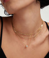 Woman wearing Bezel Lab Grown Diamond Necklace, featuring a bezel-set, lab-grown diamond in 14k solid gold. The necklace is a sparkling and ethical fashion accessory.