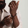 Man wearing the 6mm Gemstone Beaded Bracelet, featuring a close-up of his hand showcasing the handcrafted sterling silver beads with a swivel clasp.