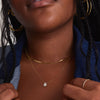 Mosaic Pear Diamond Necklace showcased on a woman's neck, featuring an array of diamond cuts and shapes, handcrafted in 14k gold for maximum shine.