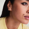 Single Pearl Chain Stud earring on a woman's ear, featuring a delicate chain and a pearl accent, showcased in a close-up view.