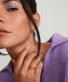 Close-up of a woman wearing the Heirloom Ring, showing its intricate design and prominent placement on her hand, highlighting its elegance and timeless appeal.