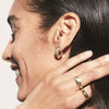 Close-up of a woman's ear showcasing Pavé Diamond Croissant Dôme Hoops in 14k solid gold with pavé diamonds.