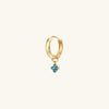 Gold hoop earring featuring a single blue gemstone cluster charm, ideal for personalizing and enhancing your everyday look.