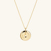 Zodiac Pendant Necklace: gold necklace with a spinning disc pendant featuring a constellation design, set with white sapphire gemstones.