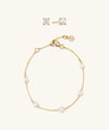 The Everyday Set: gold chain and pearl necklace, gold bracelet with pearls, and round topaz stud earrings.