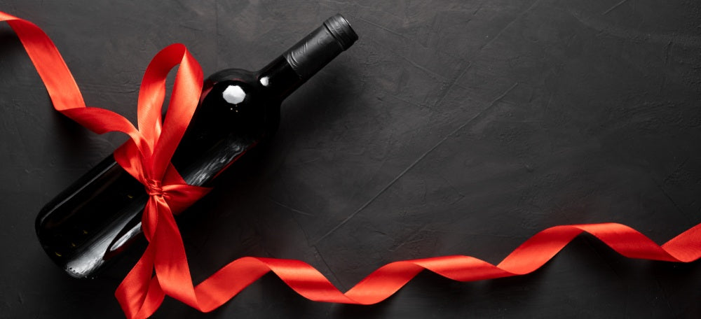 Wine bottle with ribbon tied from it.