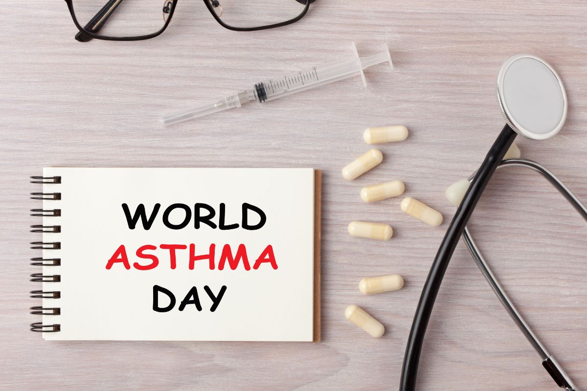 World asthama day written on a diary with stethoscope and some medicine kept with it.