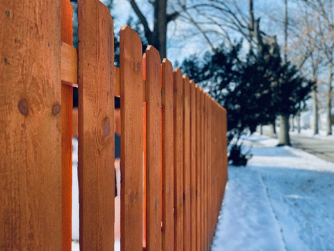 cedar fence in the snow