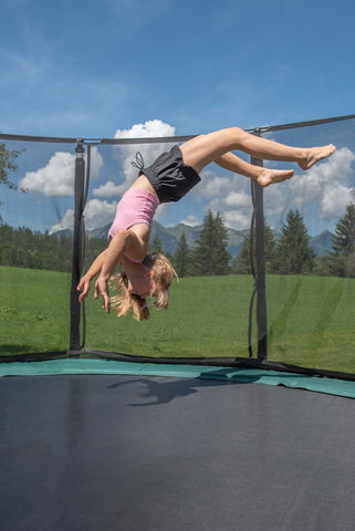 girl bouncing on trampoline