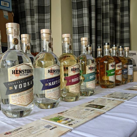 A picture of a table full of each bottle of henstone alcohol