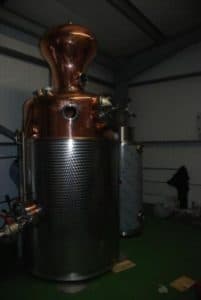 An image of a fully assembled alcohol still in a warehouse