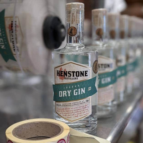 A picture of the Henstone Dry Gin product line with a row of bottles