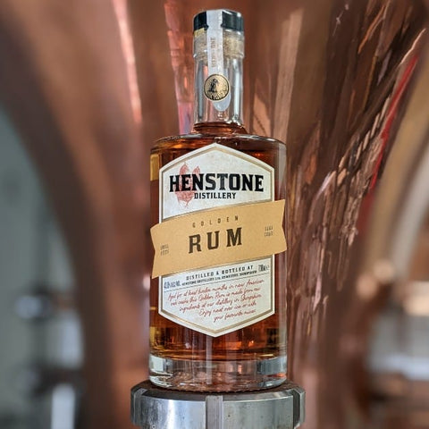A close up picture of a henstone branded rum bottle