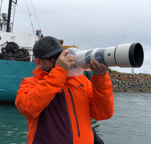 Wildlife photographer Dan M Lee using Outex waterproof case on a 600mm Sony lens in Alaska