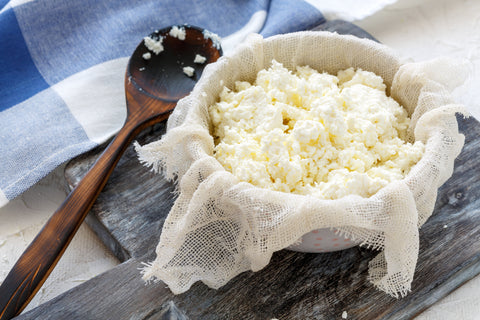Cheesecloth removing whey from cheese