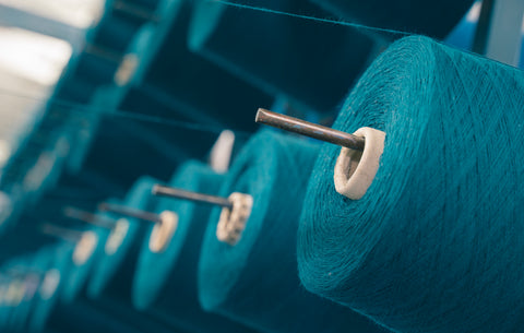 Vibrant yarns neatly arranged in a Ravenox creel, ready for precision rope making.