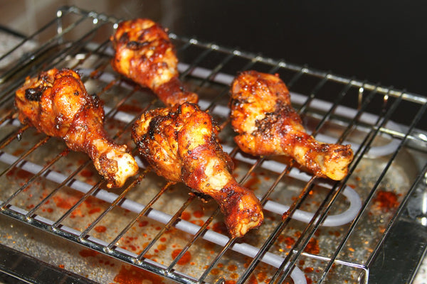 grilled chicken drumsticks with savory caramel on a grill