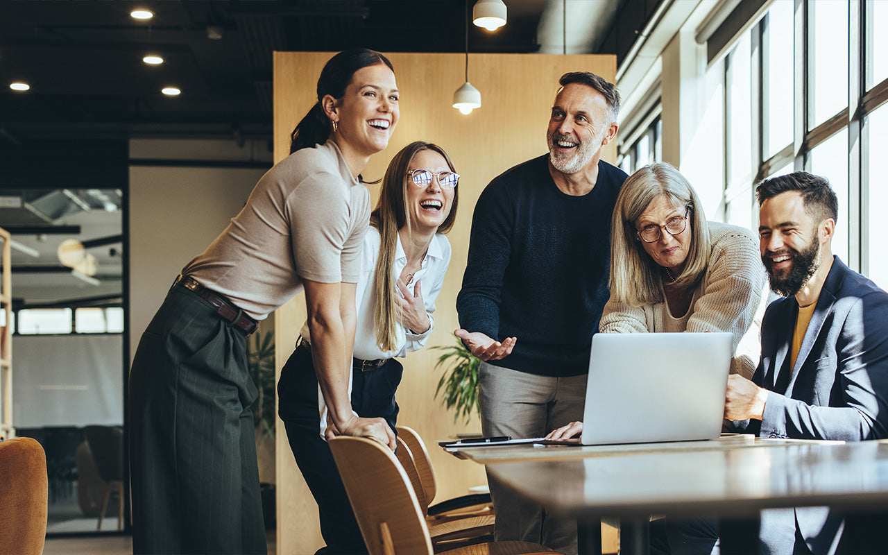 A group of people smiling in an office